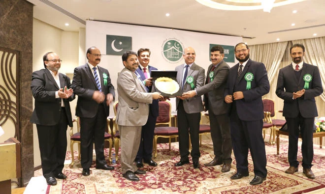 Pakistani Ambassador Khan Hasham bin Saddique and new PIF office bearers present an appreciation plaque to businessman Amir Shahzad, in Riyadh recently.