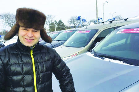 Michael’s Auto Plaza general manager Eugene Rubinchuk stands in the lot of his family’s business in East Greenbush, N.Y. The car dealership accepts bitcoin and several other digital currencies. (AP)