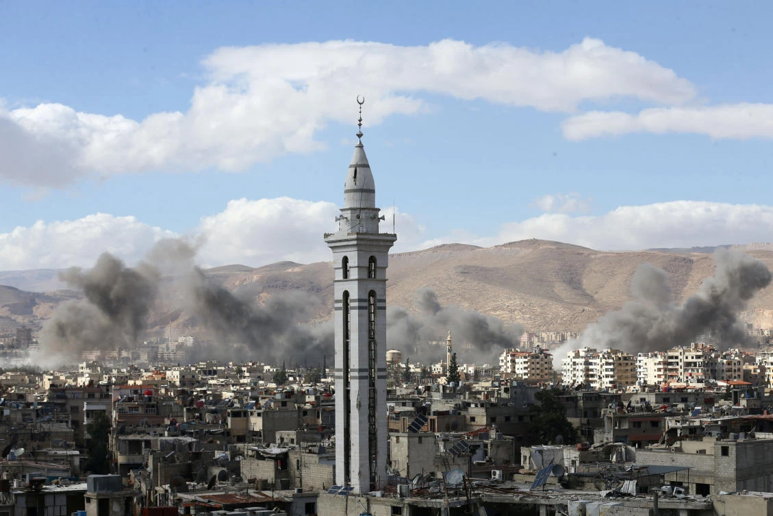 Above, smoke rises from the besieged Eastern Ghouta in Damascus. Fighting raged despite a Russian cease-fire plan, which collapsed after renewed offensive by Syrian government forces and allied militias. (Reuters)