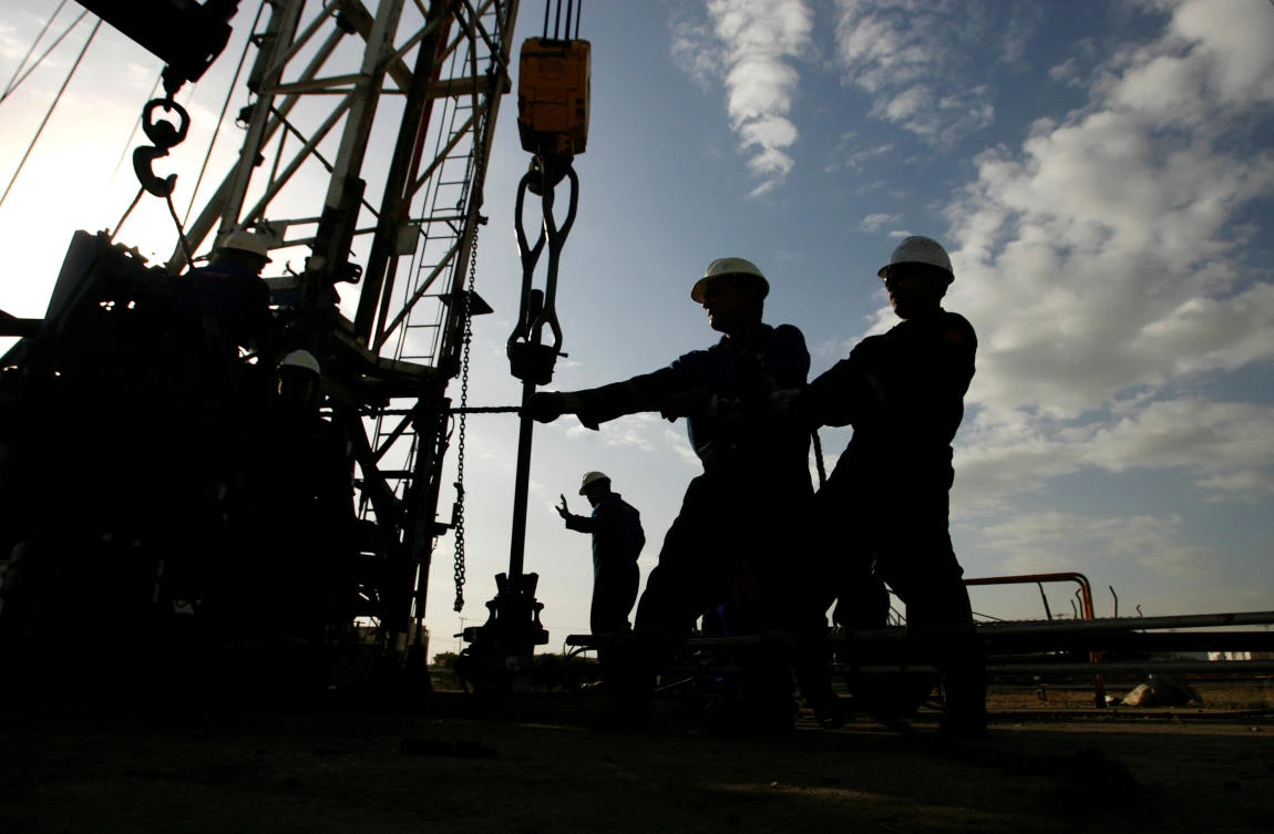 Oil workers are seen at an oil field in Venezuela this week. The price of crude is expected to rise steadily this year but remain in a tight band dictated by US shale output according to a new survey of analysts. (Reuters)