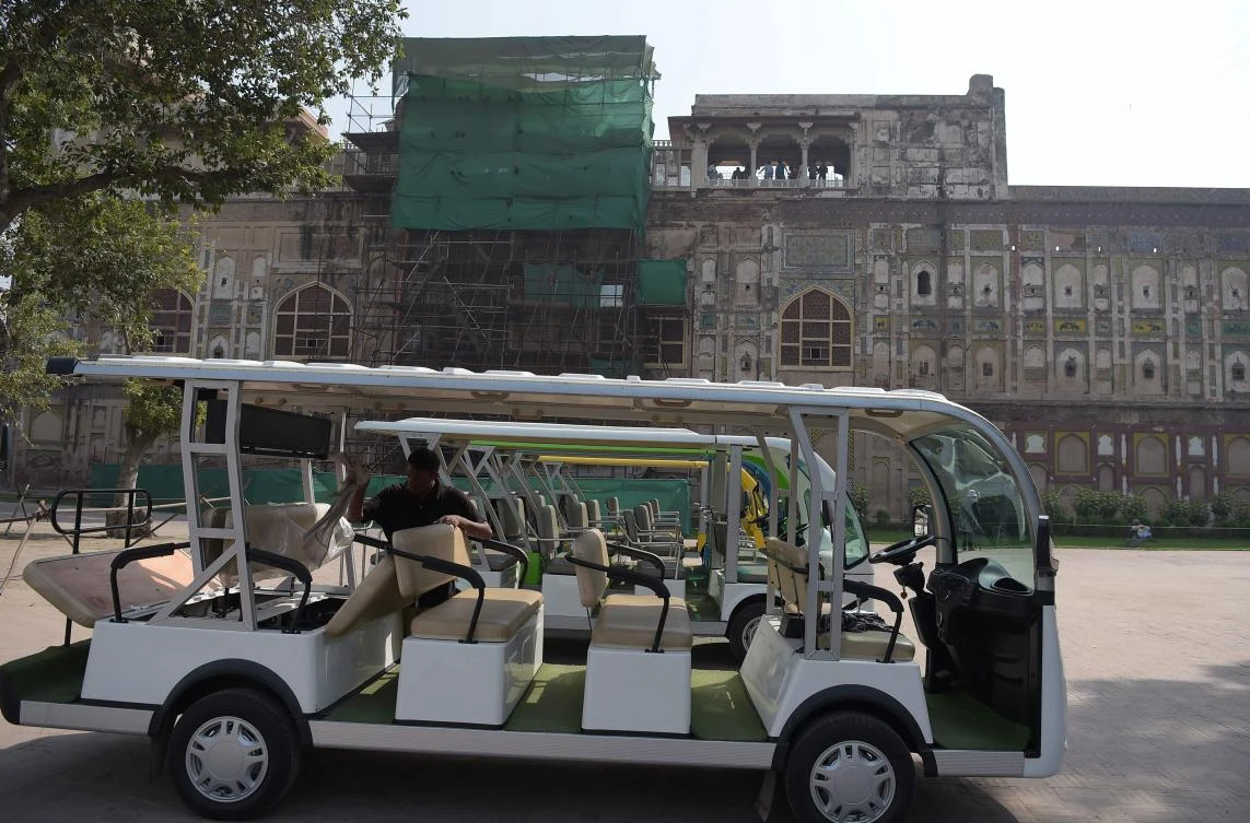 A worker cleans a golf cart for tourists to visit the historic Mughal-era Lahore Fort in the Pakistani city of Lahore. (AFP)