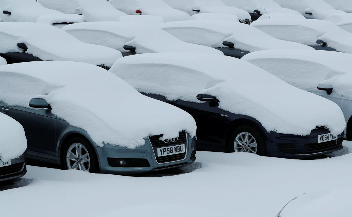 Cars sit covered in snow at an Audi dealership in Lincoln, Britain, Mar 1, 2018. (Reuters)