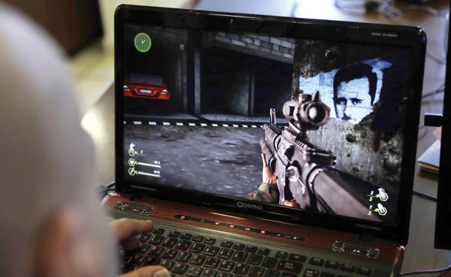 A Lebanese man plays a computer game created by Hezbollah called ‘Holy Defense’ which was inspired from the Syrian war, in a southern suburb of Beirut on Tuesday. (AFP)