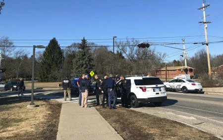 Authorities stand on the campus of Central Michigan University during a search for a suspect, in Mount Pleasant, Michigan, Friday, Mar. 2, 2018. (AP)