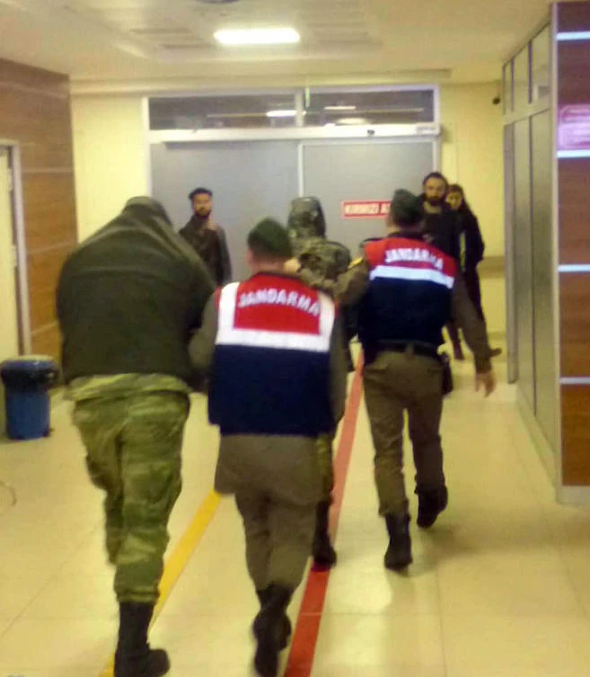 Turkish paramilitary police escort Greek soldiers Aggelos Mitretodis and Dimitros Kouklatzis in Edirne, Turkey. The Greek soldiers were arrested for allegedly entering a Turkish military zone and held on suspicion of attempted espionage. Greece said the border patrol soldiers had accidentally strayed into Turkey due to bad weather. (AP Photo)