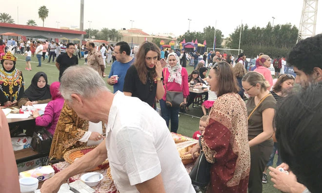 Visitors try out traditional Indonesian snacks at the country’s booth.