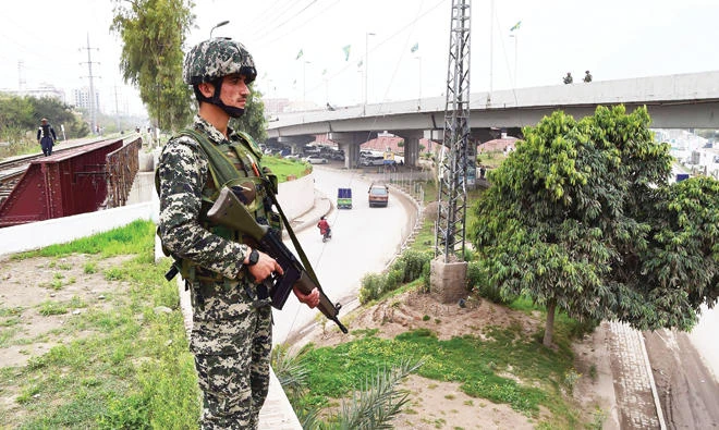 A Pakistan Army soldier stands guard near the provincial assembly during the Senate election in Peshawar on Saturday. (AFP)