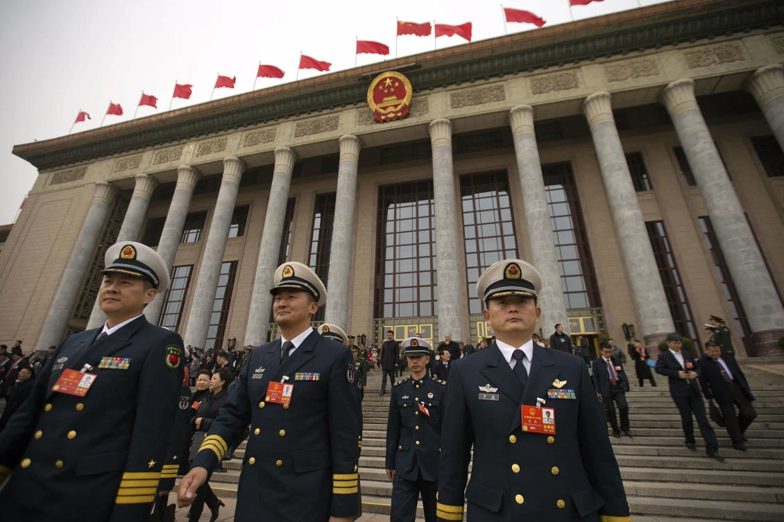 Military delegates leave after a meeting at the Great Hall of the People ahead of Monday's opening session of China's National People's Congress (NPC) in Beijing, Sunday, March 4, 2018. (AP)