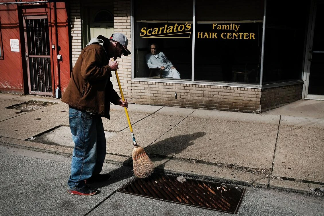 Unemployed Jesse Bowman sweeps the street for money in the town of Clairton, home to a United States Steel Corporation. In a controversial move that has angered EU leaders, President Donald Trump has announced a plan to place tariffs on steel and aluminum imports, stirring trade tensions with China. (AFP)