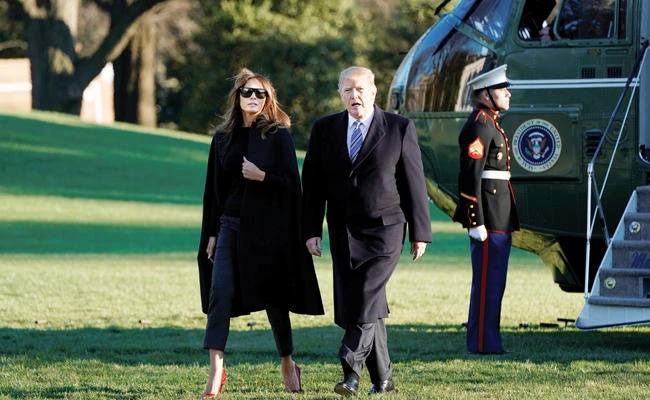 US President Donald Trump walks with First Lady Melania Trump on South Lawn of the White House upon their return to Washington from Palm Beach, Florida, on Saturday. (Reuters)