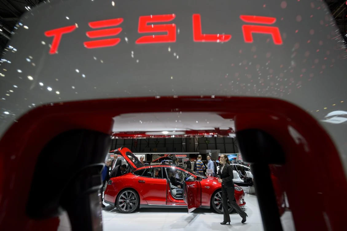 Visitors at the booth of US electric carmaker Tesla Motors at the Geneva Car Show. Electric cars sales are accelerating, posing questions for some of the oil exporters gathering in Houston this week. (AFP)