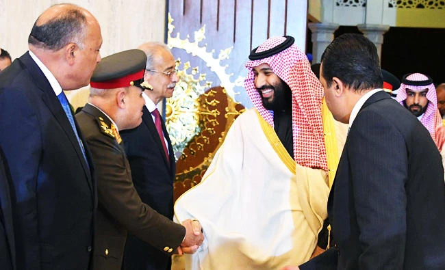 A handout photo released by the Egyptian Presidency on March 4, 2018 shows Saudi Arabia's Crown Prince Mohammed bin Salman (C) shaking hands with Egyptian officials upon his arrival in Cairo. (AFP)