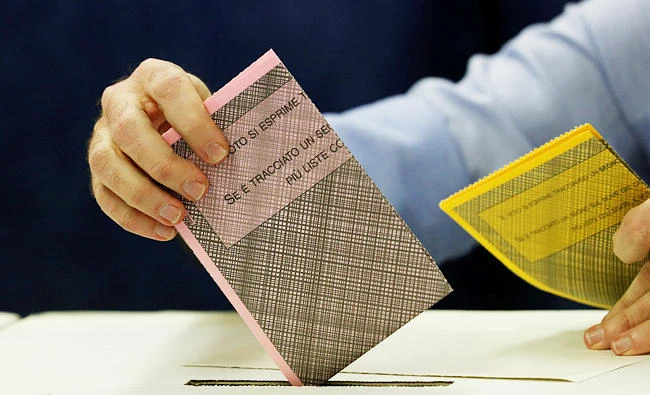 A man casts his vote at a polling station in Milan, Italy on Sunday. (REUTERS)