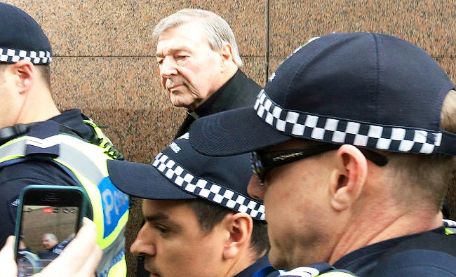 This July 26, 2017 file photo, Cardinal George Pell, rear center, Australia's highest-ranking Catholic and Pope Francis' top financial adviser, leaves Melbourne Magistrates' Court in Melbourne, Australia. (AP)