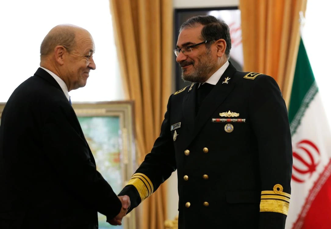 Iranian Secretary of the Supreme National Security Council Ali Shamkhani (R) shakes hands with French Foreign Minister Jean-Yves Le Drian in the capital Tehran on March 5, 2018. (AFP)
