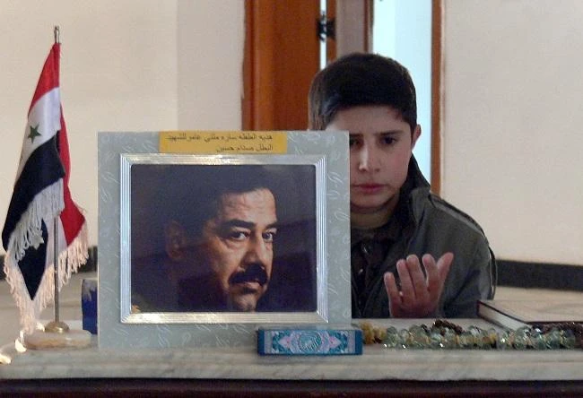 An Iraqi boy prays by the tomb of former Iraqi president Saddam Hussein in the village of Awja, near Tikrit, 180 kms (110 miles) north of Baghdad, 30 December 2007. (AFP)