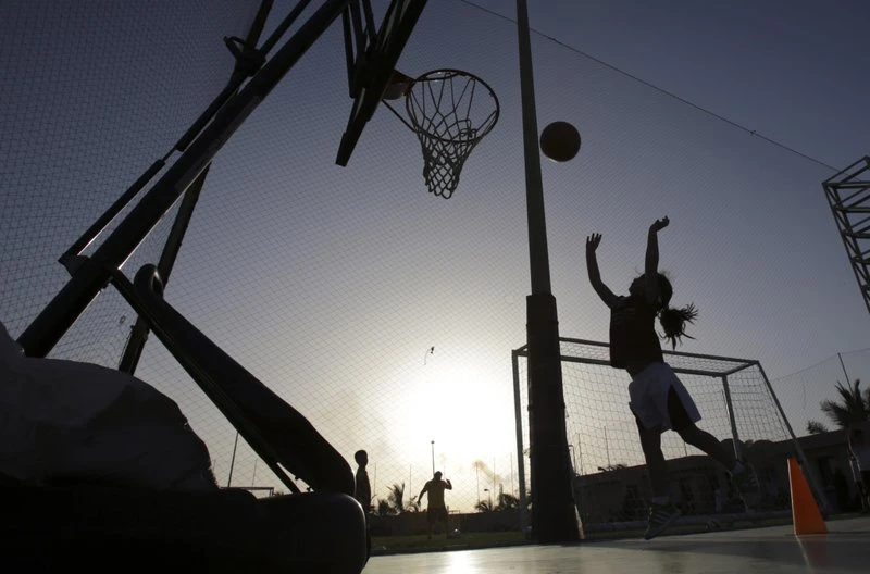 FILE- In this May 12, 2014 file photo, a girl shoots baskets during team practice at a private sports club in Jiddah, Saudi Arabia. Saudi Arabia’s Education Ministry said Tuesday July 11, 2017, it will introduce physical education classes for girls in public schools next year, a decision that comes after years of calls by women across the kingdom demanding greater rights and greater access to sports.(AP)