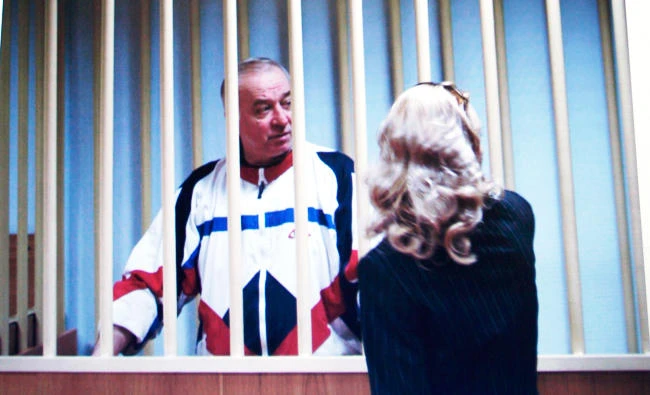 In this Aug. 9, 2006 file photo, Sergei Skripal speaks to his lawyer from behind bars seen on a screen of a monitor outside a courtroom in Moscow. (AP)