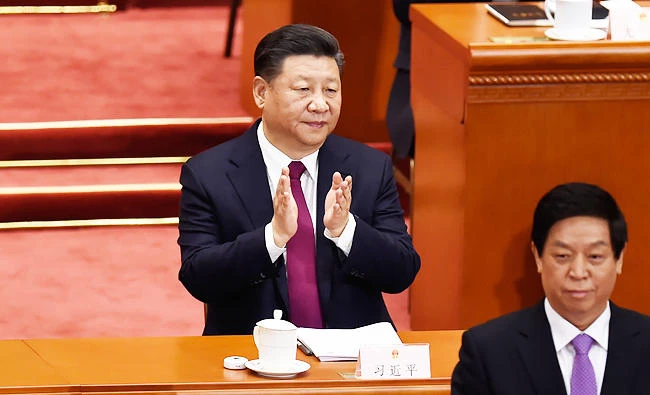 Chinese President Xi Jinping applauds during the opening session of the National People's Congress, China's legislature, at the Great Hall of the People in Beijing on Monday. (AFP)