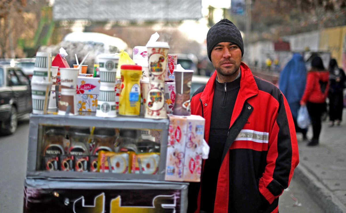 In this file photo, Najibullah Sharyari waits for customers at his coffee cart in Kabul on Jan. 8, 2018. (AFP)
