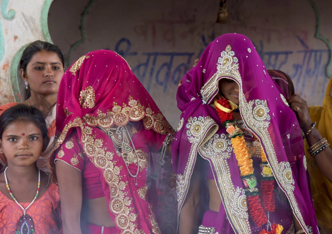 An underaged bride, right, stands with family members during her marriage at a Hindu temple near Rajgarh, Madhya Pradesh state, India.. A significant fall in child marriages in South Asia has reduced the rate of marriage for girls globally, the UN children’s agency said Tuesday. (AP/Prakash Hatvalne)