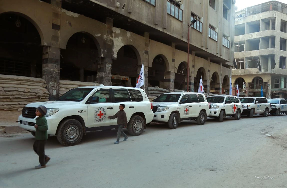 International Red Cross and UN vehicles line up in Douma in the Syrian rebel enclave of Eastern Ghouta on March 5, 2018. (AFP)