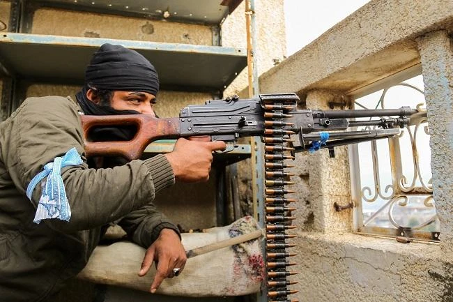 A Yemeni tribesman from the Popular Resistance Committees, supporting forces loyal to Yemen's Saudi-backed President Abedrabbo Mansour Hadi, holds a position in the country's third city Taiz. (AFP)