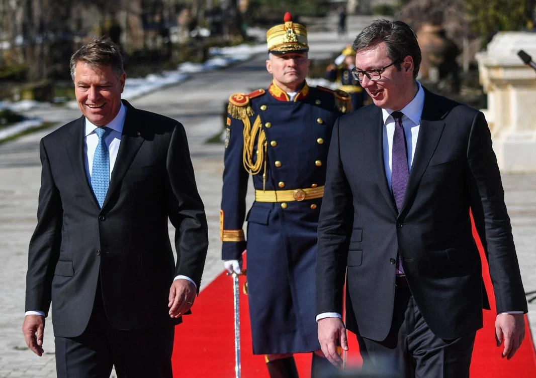 Romanian President Klaus Iohannis, left, and Serbian President Aleksandar Vucic, right, review the honor guard during an official welcoming ceremony at the presidential palace in Bucharest. (AFP)