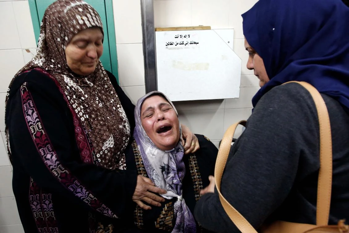 The mother of Mohammed Al-Jabari, 24, who was shot by Israeli forces during the clashes in the southern West Bank city of Hebron, mourns after learning of his passing at a hospital in the divided West Bank town of Hebron. (AFP)