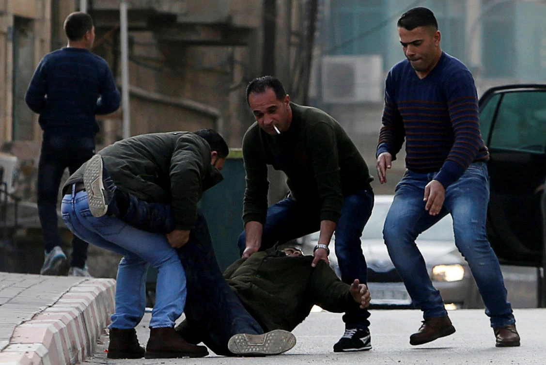 People evacuate a Palestinian who was shot dead during clashes with Israeli troops, in the occupied West Bank. (Reuters)