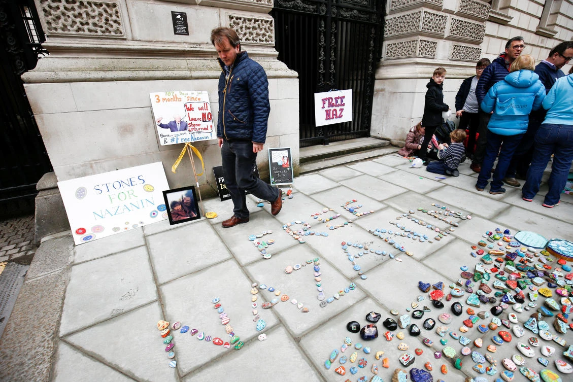 Richard Ratcliffe views stones and placards with messages placed on the pavement outside the Foreign and Commonwealth Office in London, during a demonstration to demand the release of his wife Nazanin Zaghari-Ratcliffe, who is imprisoned in Iran, Mar 10, 2018. (Reuters)