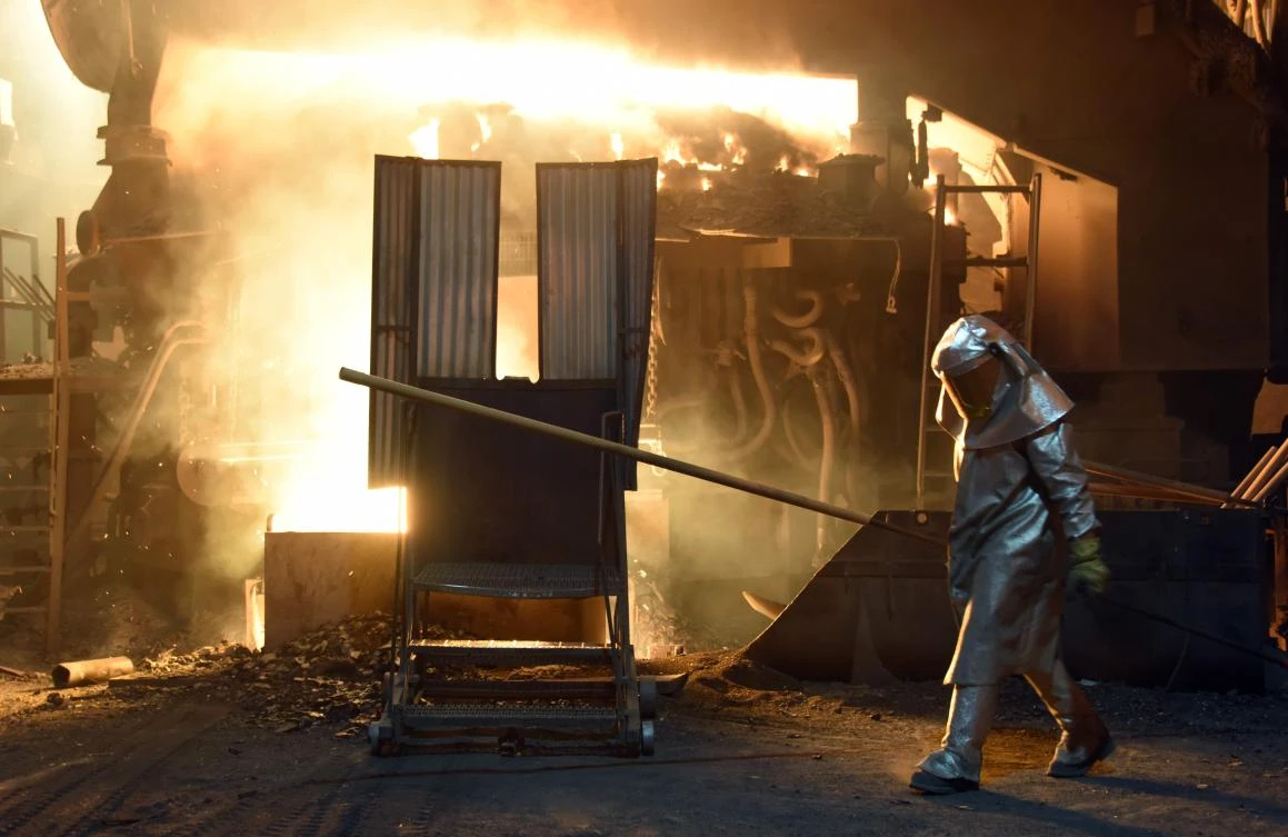 A Pennsylvania steelworker checks the temperature of molten metal in a furnace. US President Trump’s move to introduce tariffs on steel imports has triggered a global backlash and led to fears that a trade war could hurt Gulf economies. (AFP)