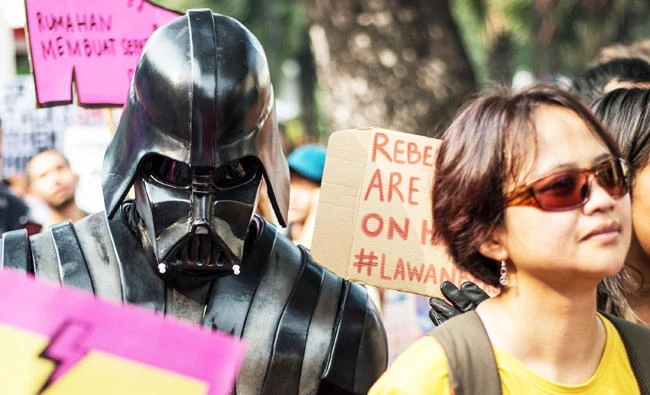 A person dressed as Darth Vader from the Star Wars movie franchise takes part in the 2018 Women's March rally in Jakarta on March 3, 2018. (AFP)
