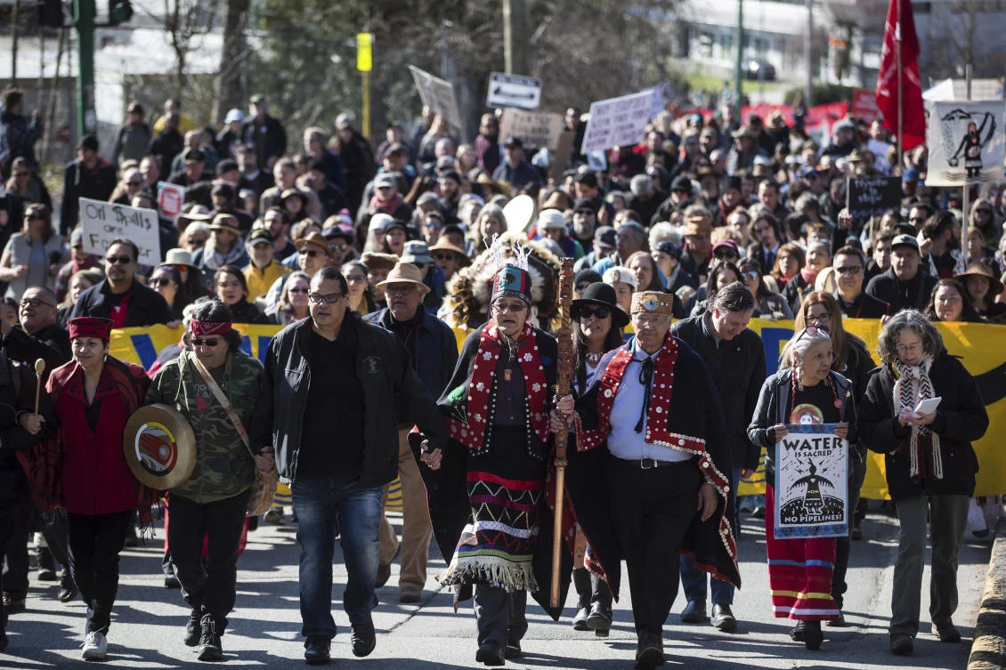 Indigenous chiefs and elders lead thousands of people in a march during a protest against the Kinder Morgan Trans Mountain pipeline expansion in Burnaby, British Columbia. (The Canadian Press via AP)