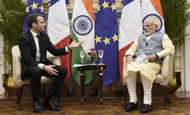 This handout photo released by the Indian Ministry of External Affairs on March 10, 2018 shows Indian Prime Minister Narendra Modi (R) and France's President Emmanuel Macron talking during a meeting in New Delhi. (AFP)