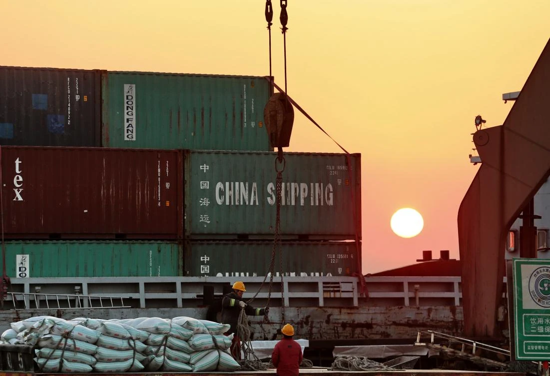 This photo taken on March 9, 2018 shows workers loading ships at a port in Nantong in China's eastern Jiangsu province. (AFP)