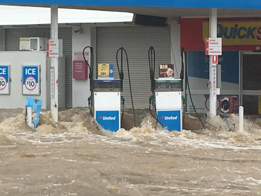 Waves crash against pumps at a flooded gas station in Queensland, Australia March 9, 2018 in this image obtained from social media. (Kieran Volpe via Reuters)