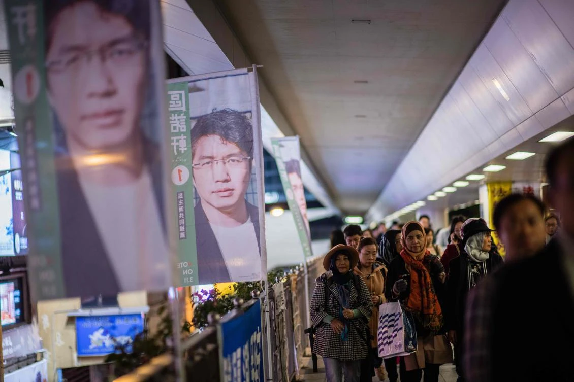 This picture taken on March 9, 2018 shows banners (L) for pro-democracy by-election candidate Au Nok-hin in Hong Kong. Hong Kong’s pro-democracy camp will try to claw back lost seats Sunday in a controversial by-election that goes to the heart of the city’s political divide. (AFP/Anthony Wallace)