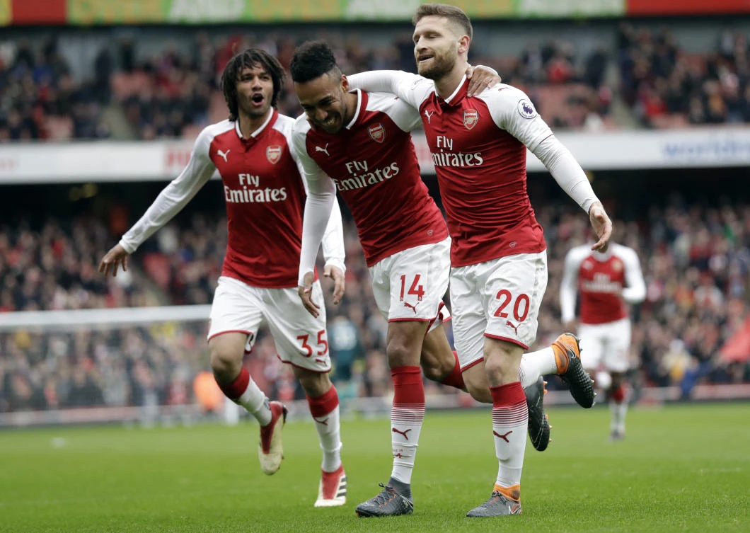 Arsenal's Shkodran Mustafi, right, celebrates after scoring his side's opening goal with Arsenal's Pierre-Emerick Aubameyang, center and Arsenal's Mohamed Elneny during the English Premier League soccer match between Arsenal and Watford. (AP)