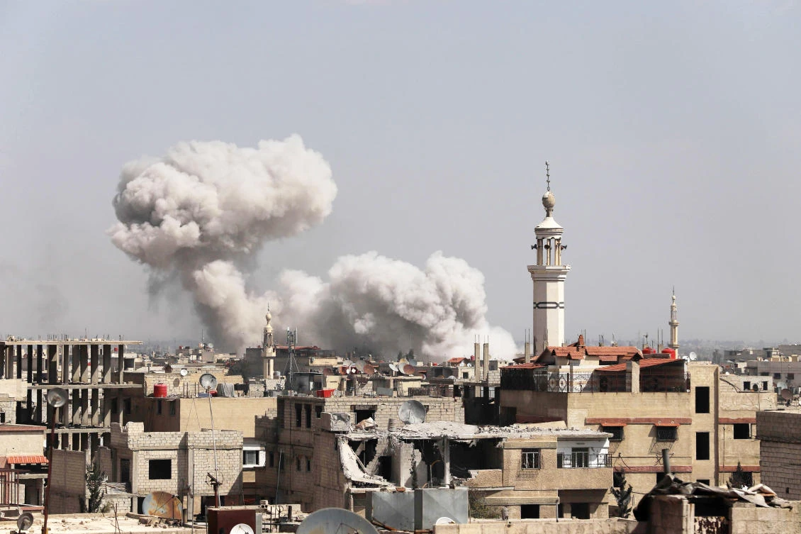 Smoke billows following regime forces' bombardment on Kafr Batna, in the besieged Eastern Ghouta region. (AFP)