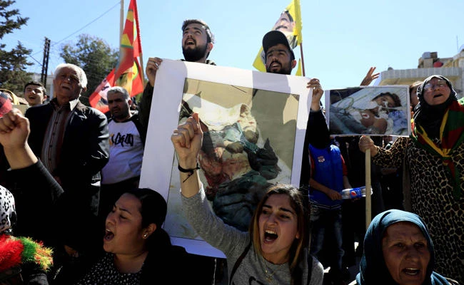 Syrian Kurds take part in a protest in the northeastern city of Qamishli against the Turkish assault on the Syrian border enclave of Afrin on March 11, 2018. (AFP / Delil Souleiman)