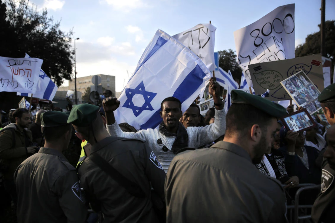 Israeli border police stand guard as Ethiopian Israelis protest in front of the Knesset, Israel’s parliament, in Jerusalem. Hundreds of Ethiopian immigrants demanded the government fulfill a pledge to bring some 8,000 of their countrymen remaining in Ethiopia to Israel. (AP Photo)