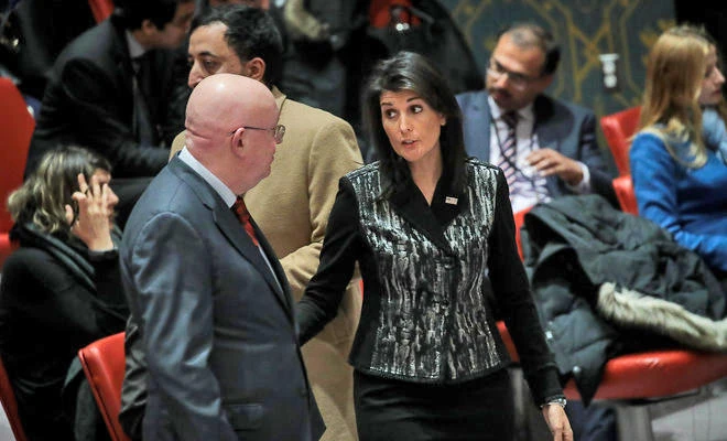 Russian Ambassador to the UN Vasilly Nebenzia talks with his US counterpart Nikki Haley before the start of a UN Security Council meeting concerning the situation in Iran, January 5, 2018 in New York City. (AFP)
