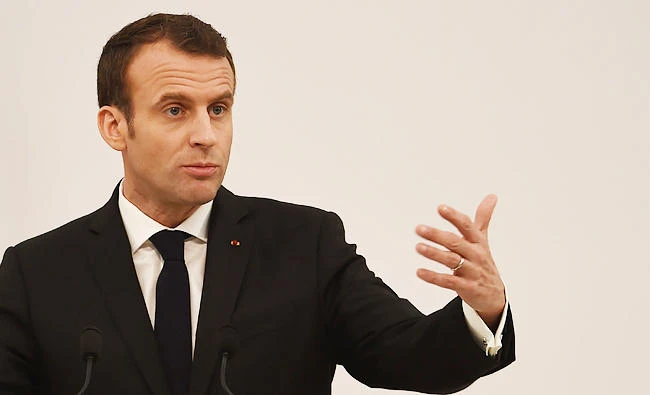 French President Emmanuel Macron addresses a press conference in the Indian city of Varanasi on Monday. (AFP)