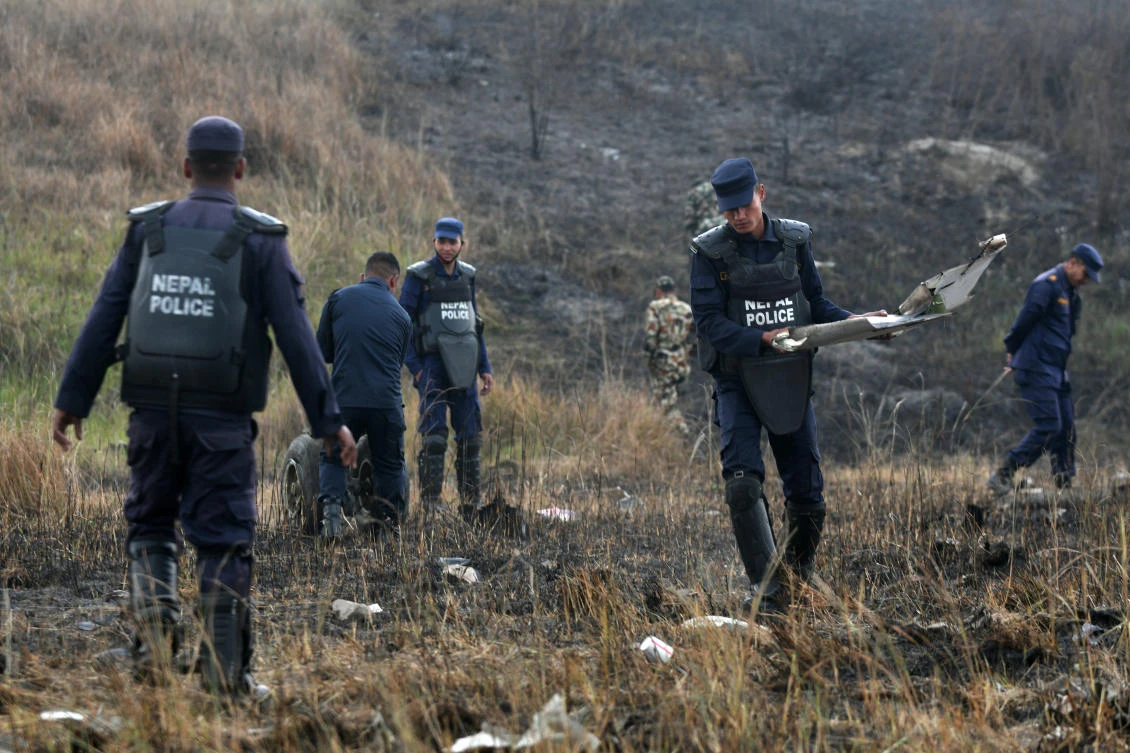 Nepali rescue workers collect wreckage from an airplane that crashed near the international airport in Katmandu on March 12, 2018. (Prakash Mathema/AFP)