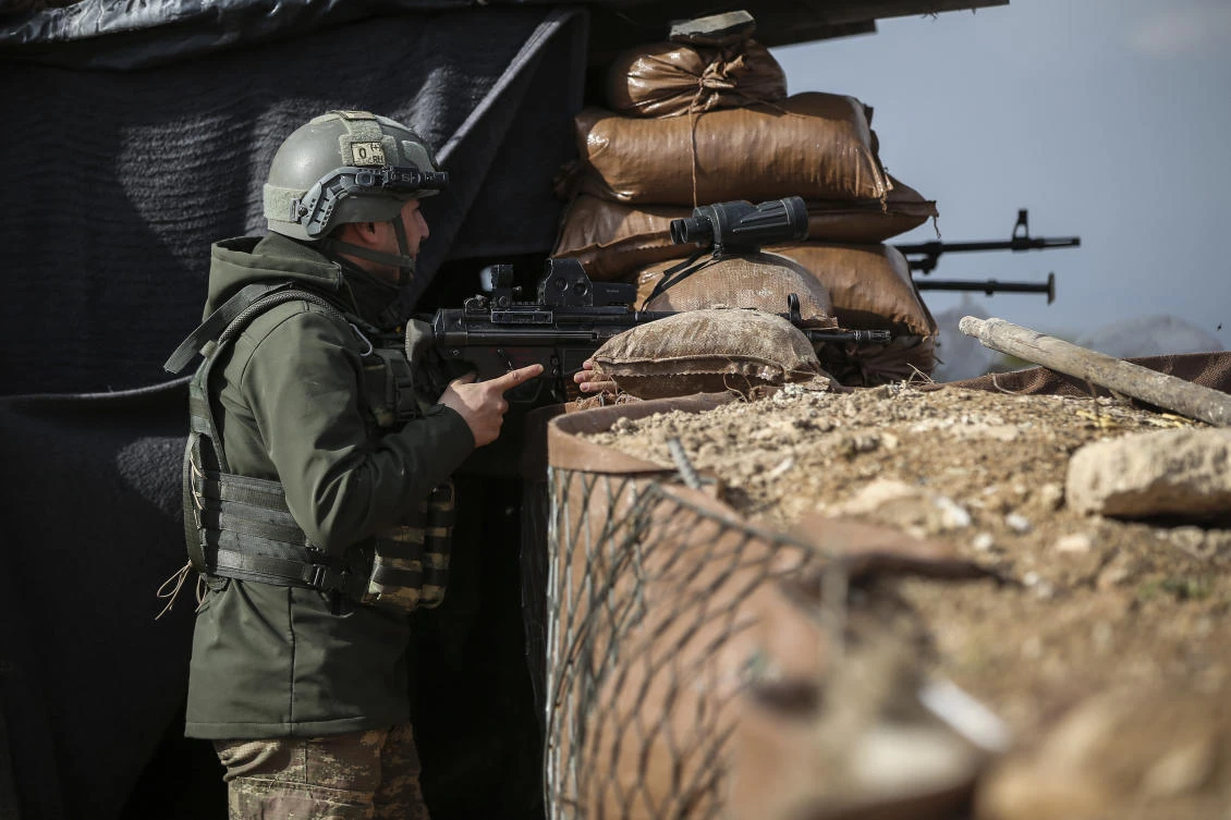 A Turkish soldier holds a position atop the Bursayah hill in the greater Afrin district, Syria, during a Turkish government-organized media tour into northern Syria, Saturday, March 3, 2018. (AP/Emrah Gurel)