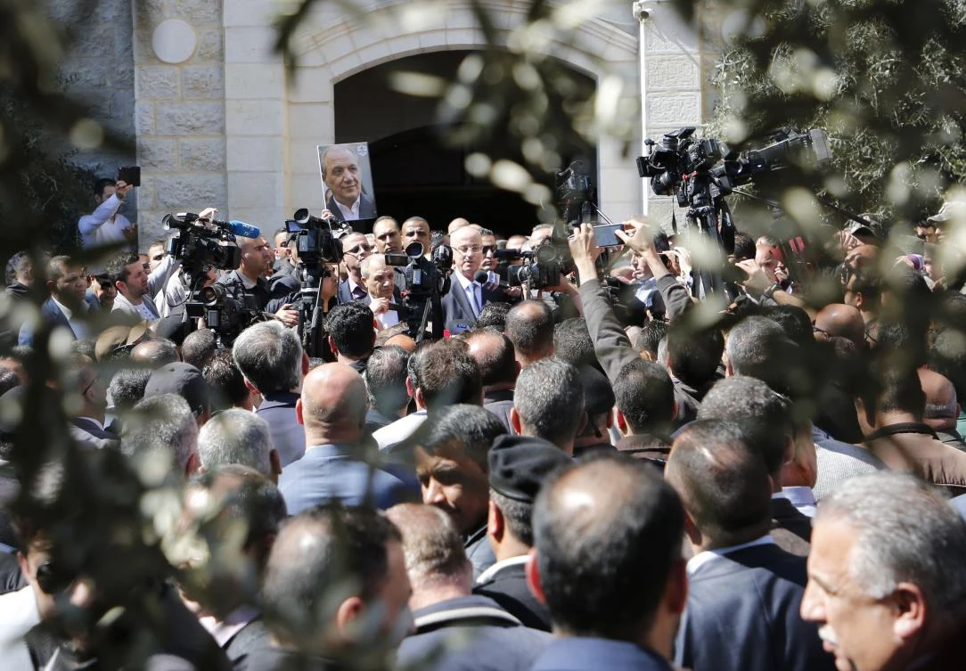 Palestinian Prime Minister Rami Hamdallah addresses the media upon his arrival in the West Bank town of Ramallah following his return from the Gaza Strip where an explosion targeted his convoy. (AFP)