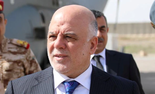 Iraqi Prime Minister Haider Al-Abadi walks with officers as he arrives in Mosul, Iraq, in this March 14, 2018 photo. (REUTERS)