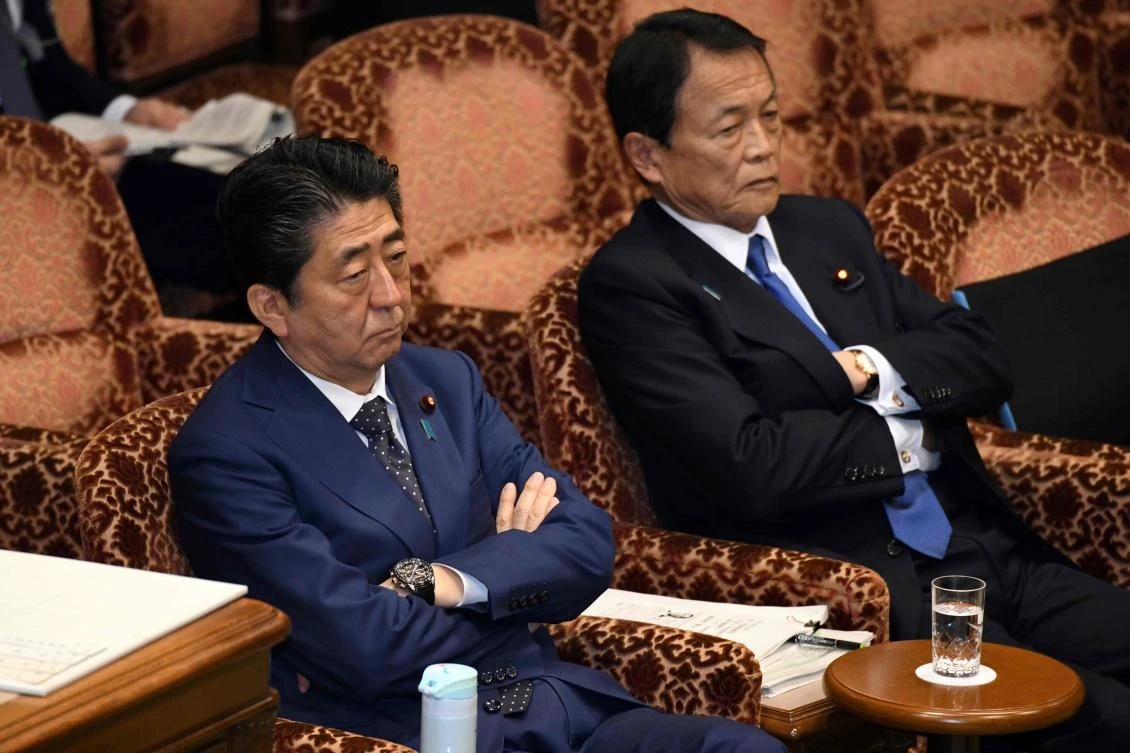 Japan’s Prime Minister Shinzo Abe, left and Finance Minister Taro Aso attend a upper house budget committee session at parliament in Tokyo on March 14. Abe and Aso have been on the ropes in recent days following revelations that key documents relating to a controversial land sale were doctored before being sent to MPs. (AFP)