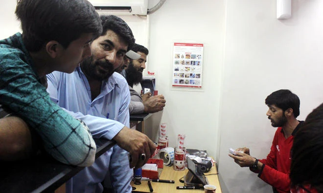 Cricket fans inside at a ticketing center at Cooperative clothes market in Saddar downtown, Karachi. (Photo Arab News)